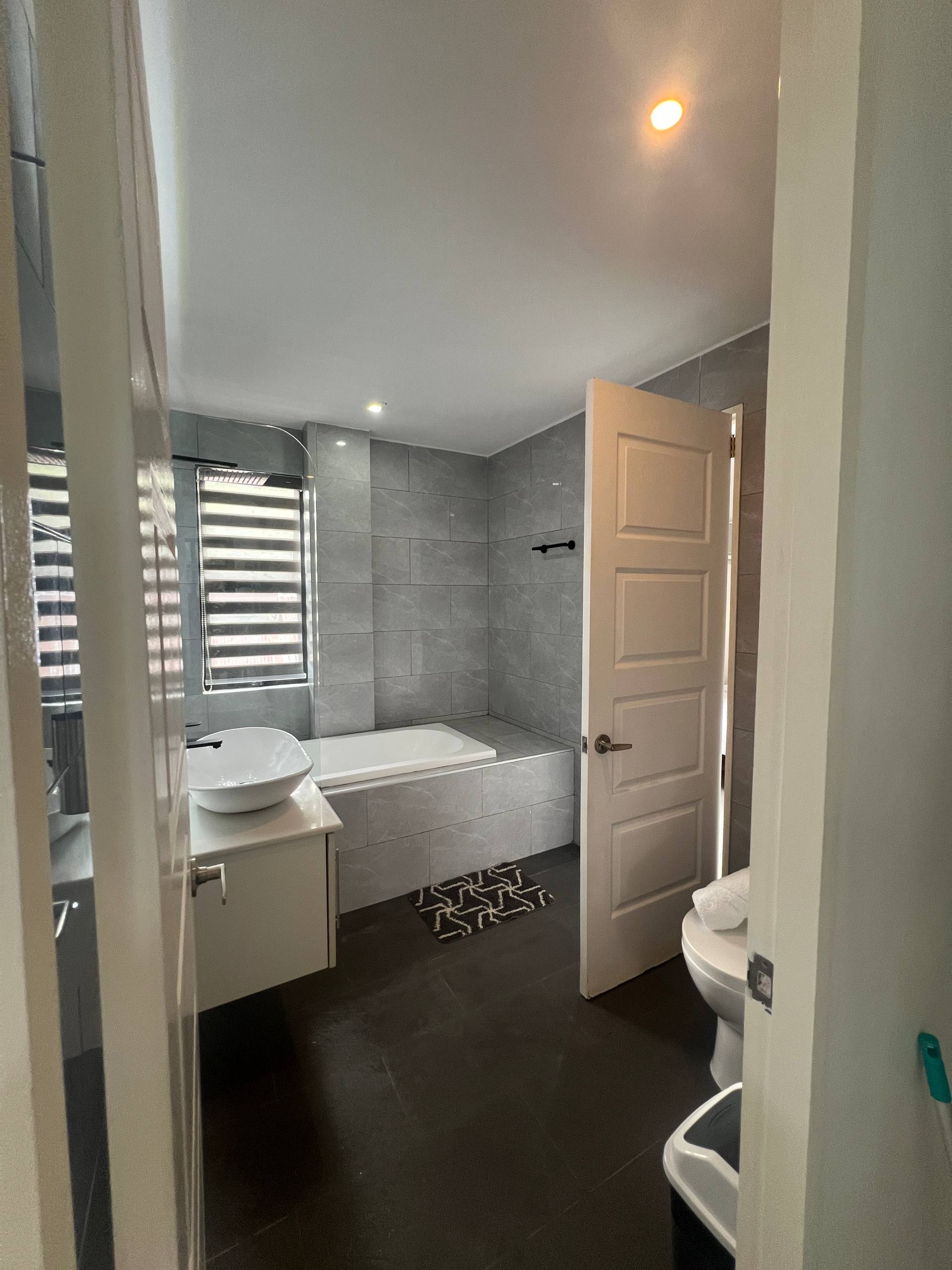 En-suite bathtub and shower partition view from doorway