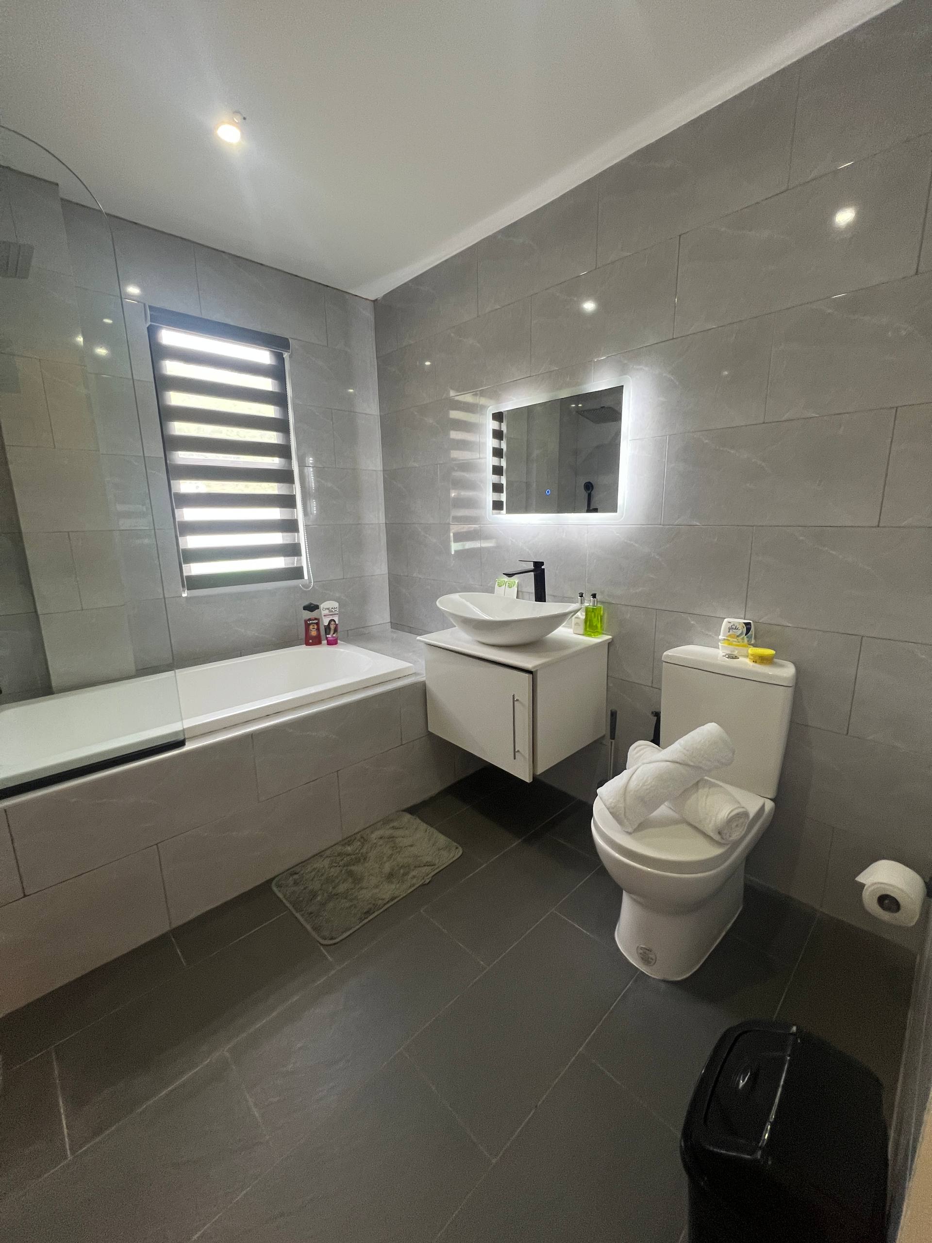 En-suite bathroom with black fixtures and marble tiles
